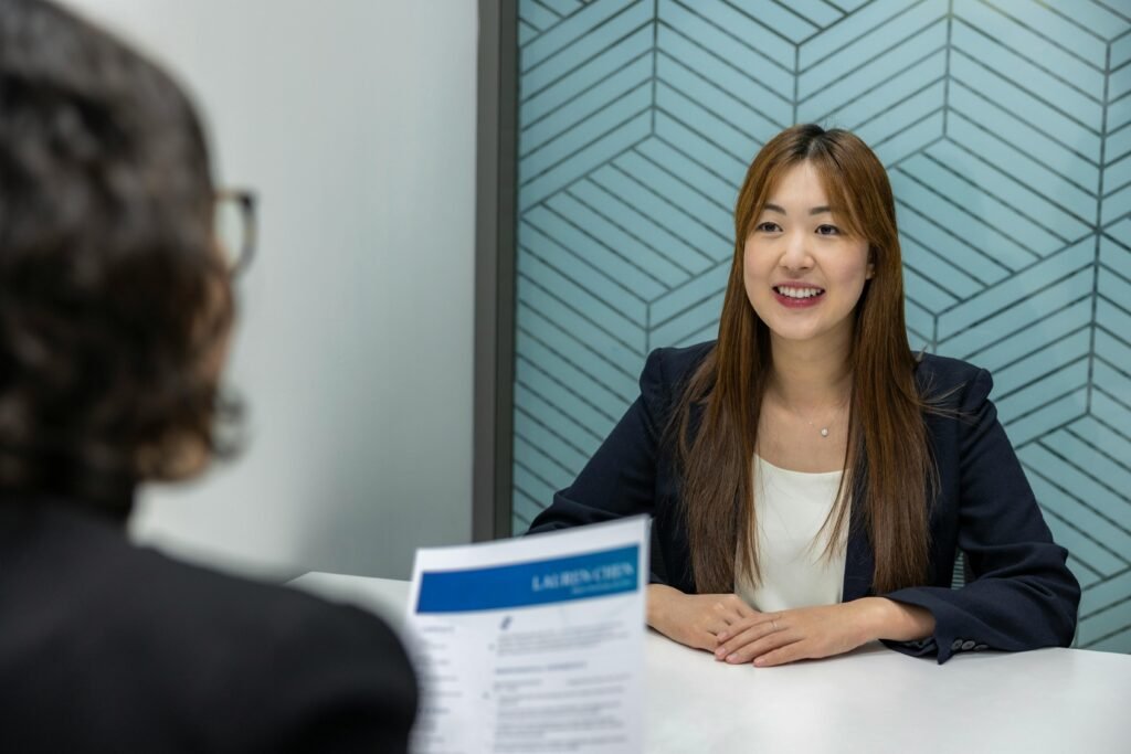Why Job Boards and Legacy Outsourcing No Longer Scale? 3 Young woman in a business meeting with an interviewer, showcasing confidence and professionalism.